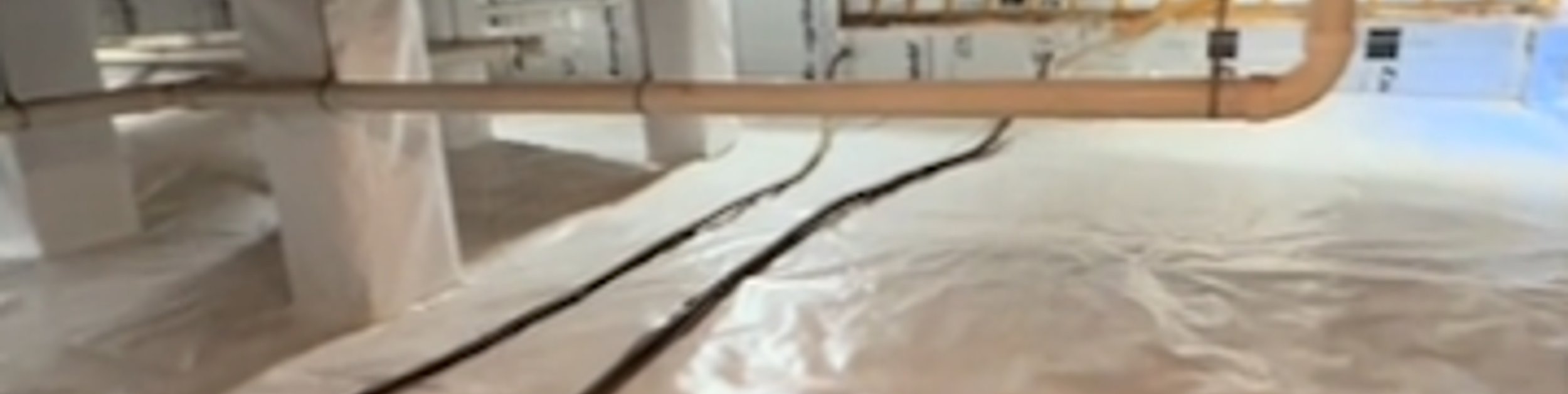 Encapsulated crawl space with wrapped piers, a sealed floor liner, and a drain pipe